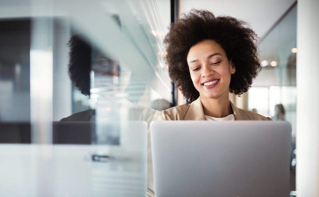 Young,African,American,Woman,Working,With,Tablet,In,Office