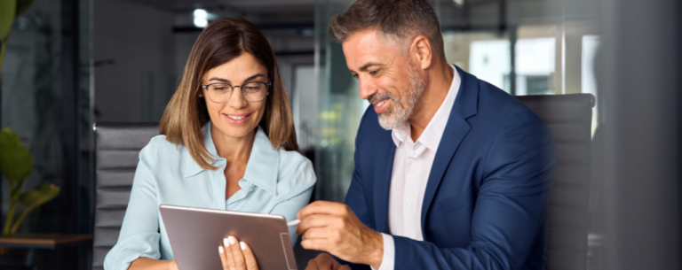man and woman looking at the tablet