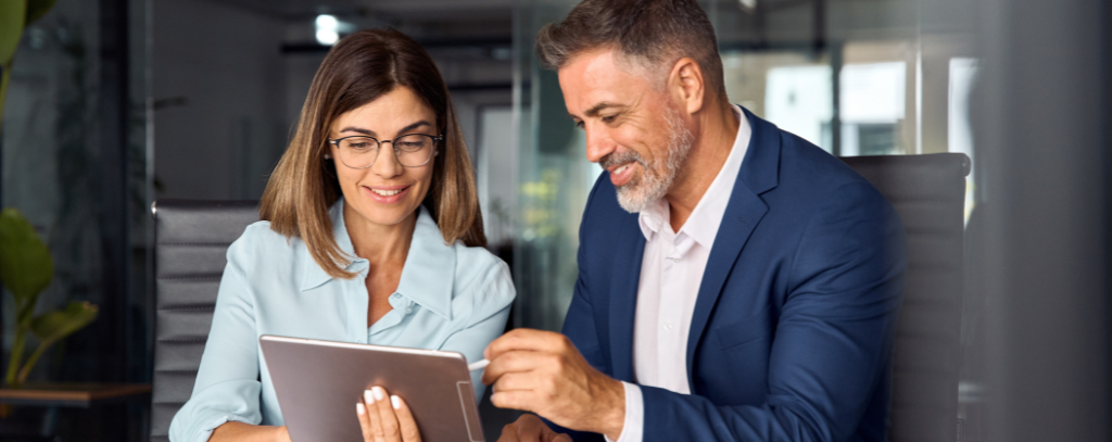 man and woman looking at the tablet